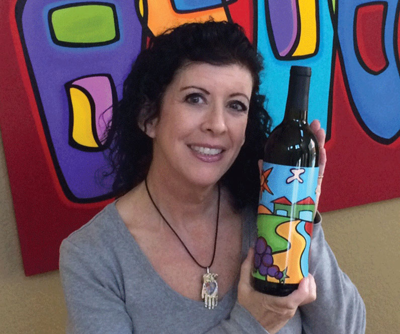 Sonya Paz with wine label for Villa del Monte Winery