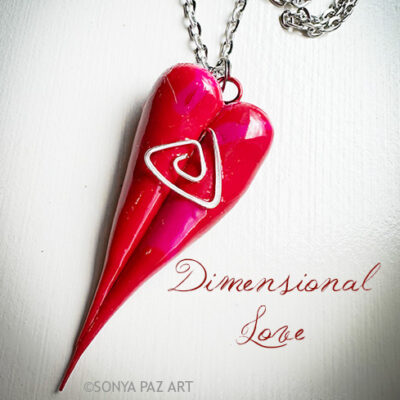 Pink double-heart pendant necklace on a silver chain, with the script title 'Dimensional Love' beside it on a white background.