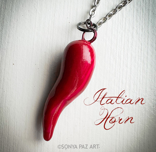 Red Italian horn pendant on a silver chain, against a light background; text reads 'Italian Horn'.